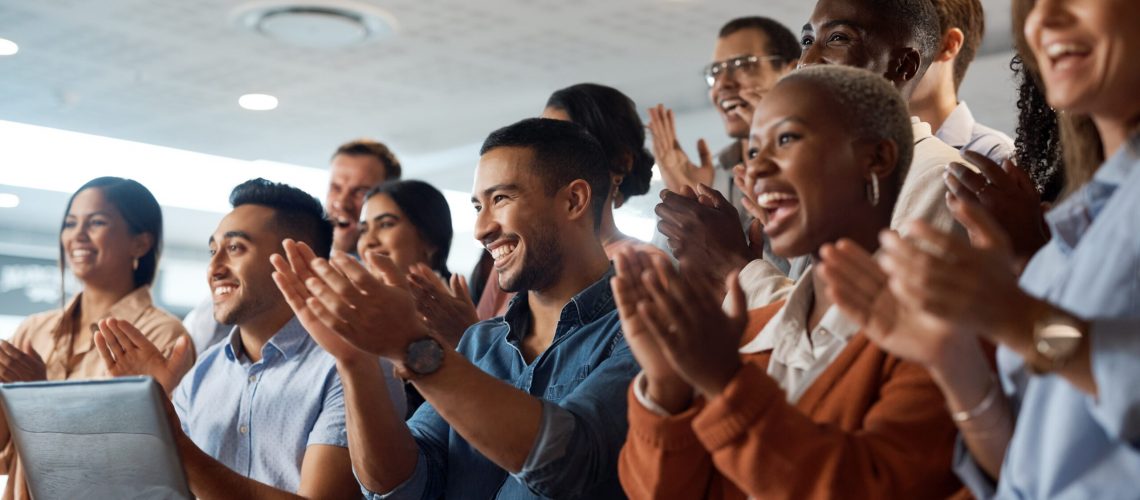 Applause, support and success with a business team clapping as an audience at a conference or seminar. Meeting, wow and motivation with a group of colleagues or employees cheering on an achievement.